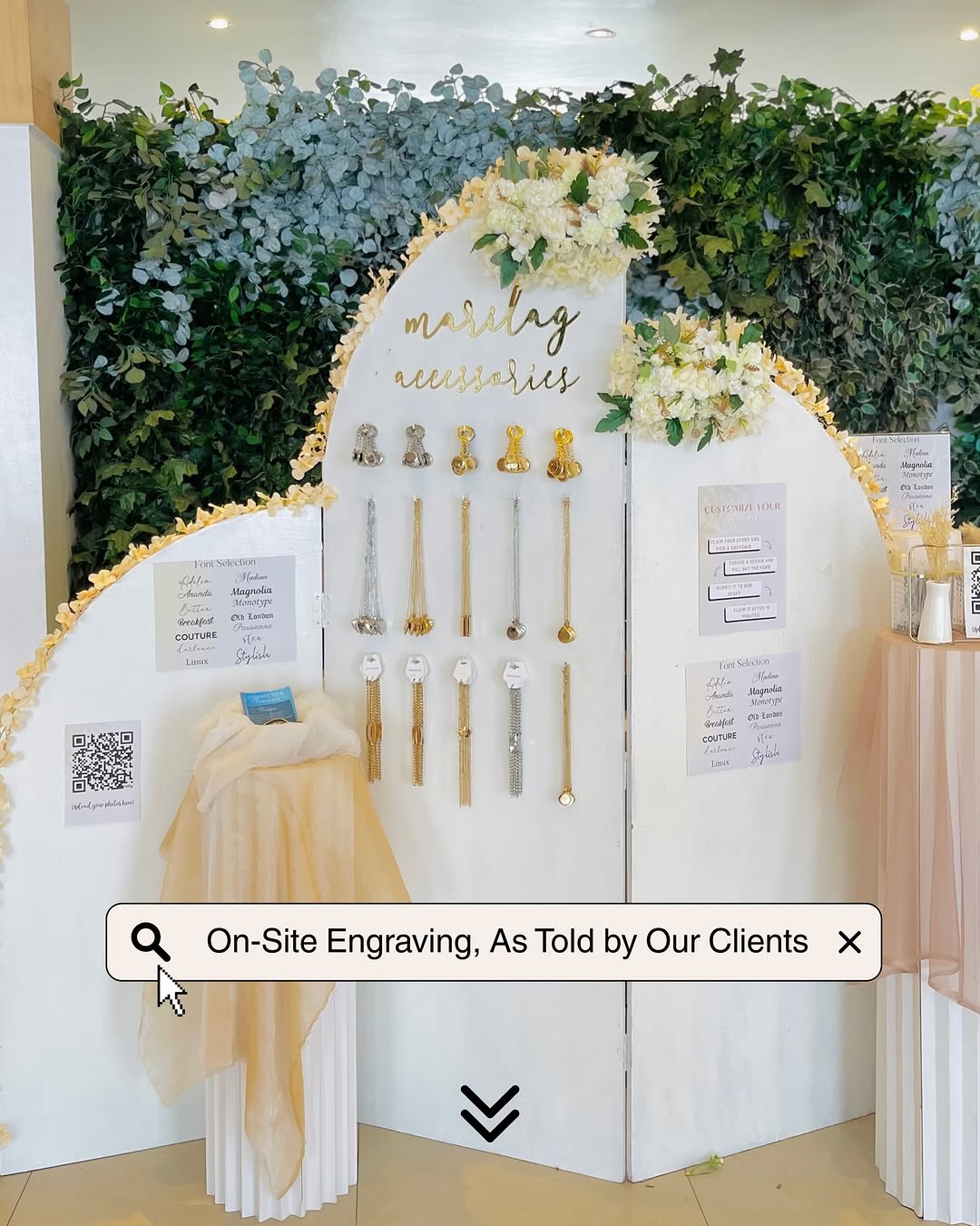 Marilag Accessories engraving booth at an event with floral display backdrop